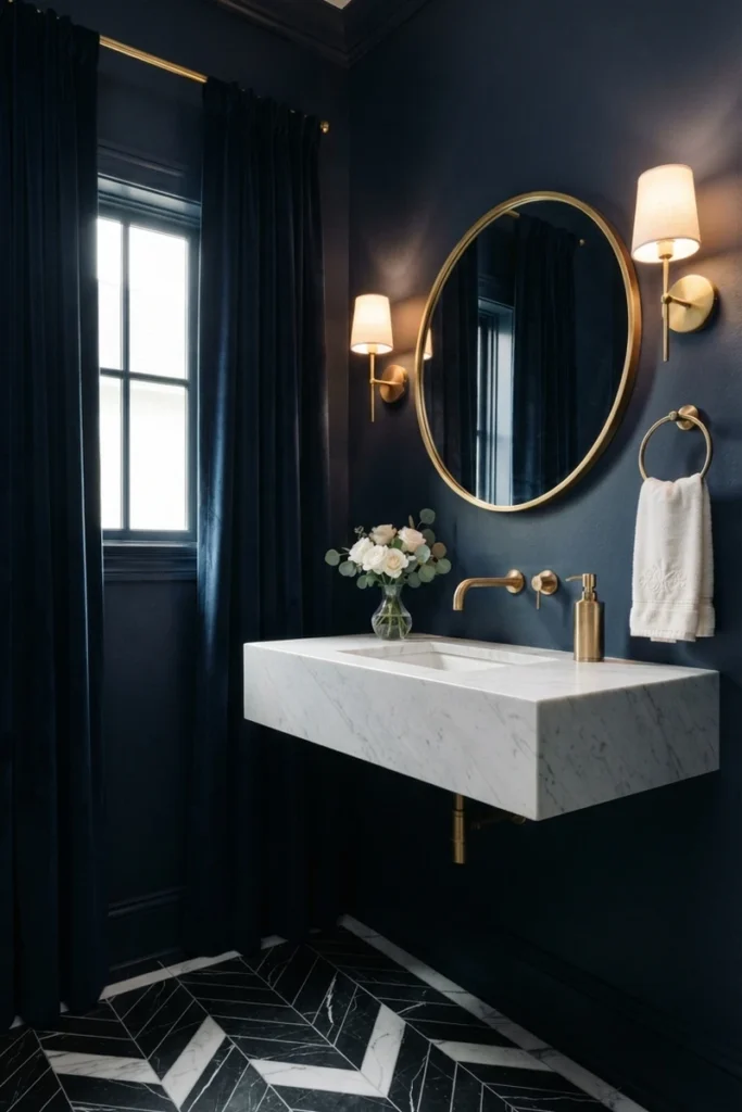Bathroom curtain colors with deep navy velvet curtains in a navy powder room with brass sconces, a round brass mirror and a marble sink
